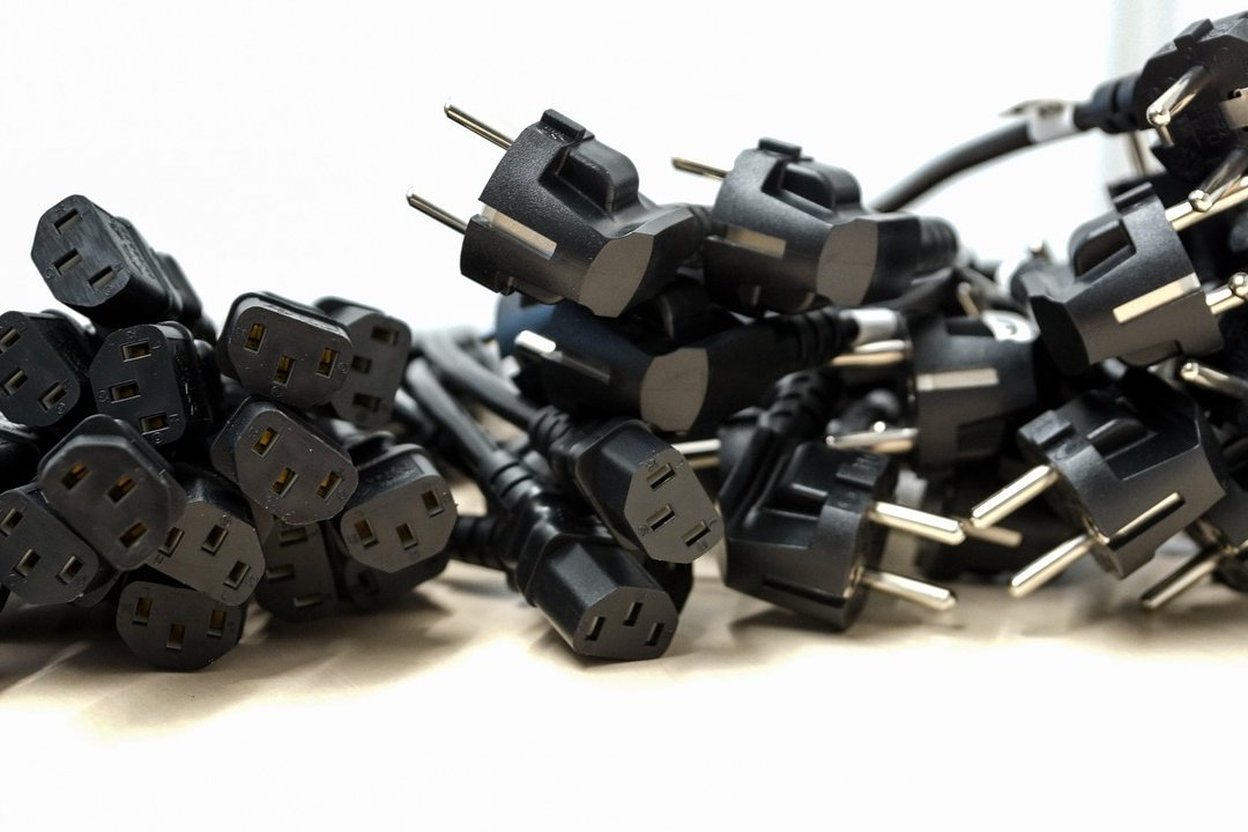 A heavy-duty outdoor extension cord coiled on a garage floor