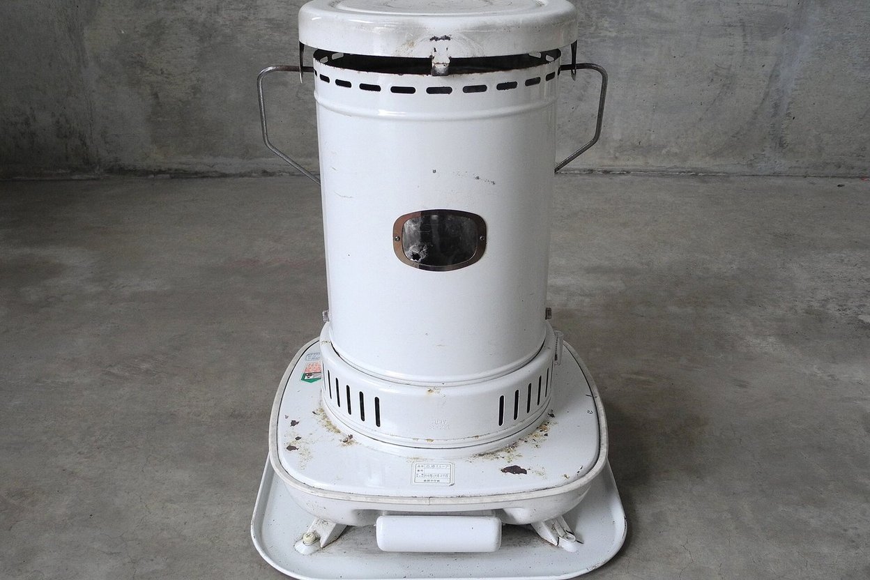 A portable kerosene heater on a concrete floor