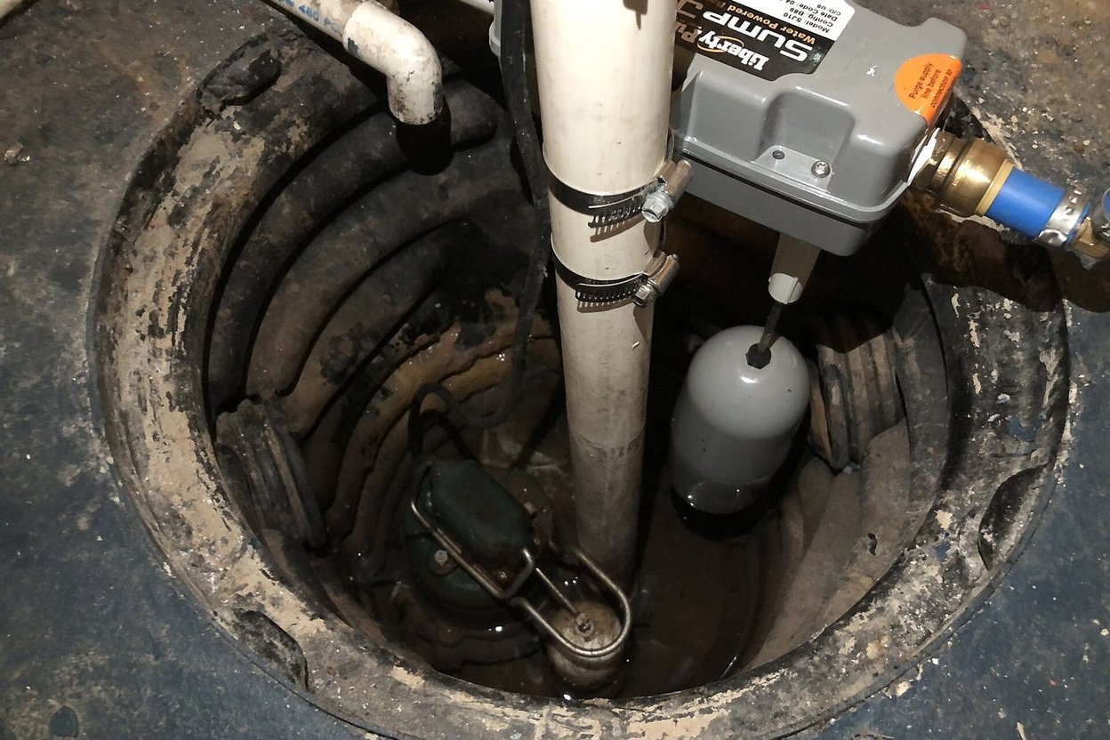 A sump pump in a basement sump pit