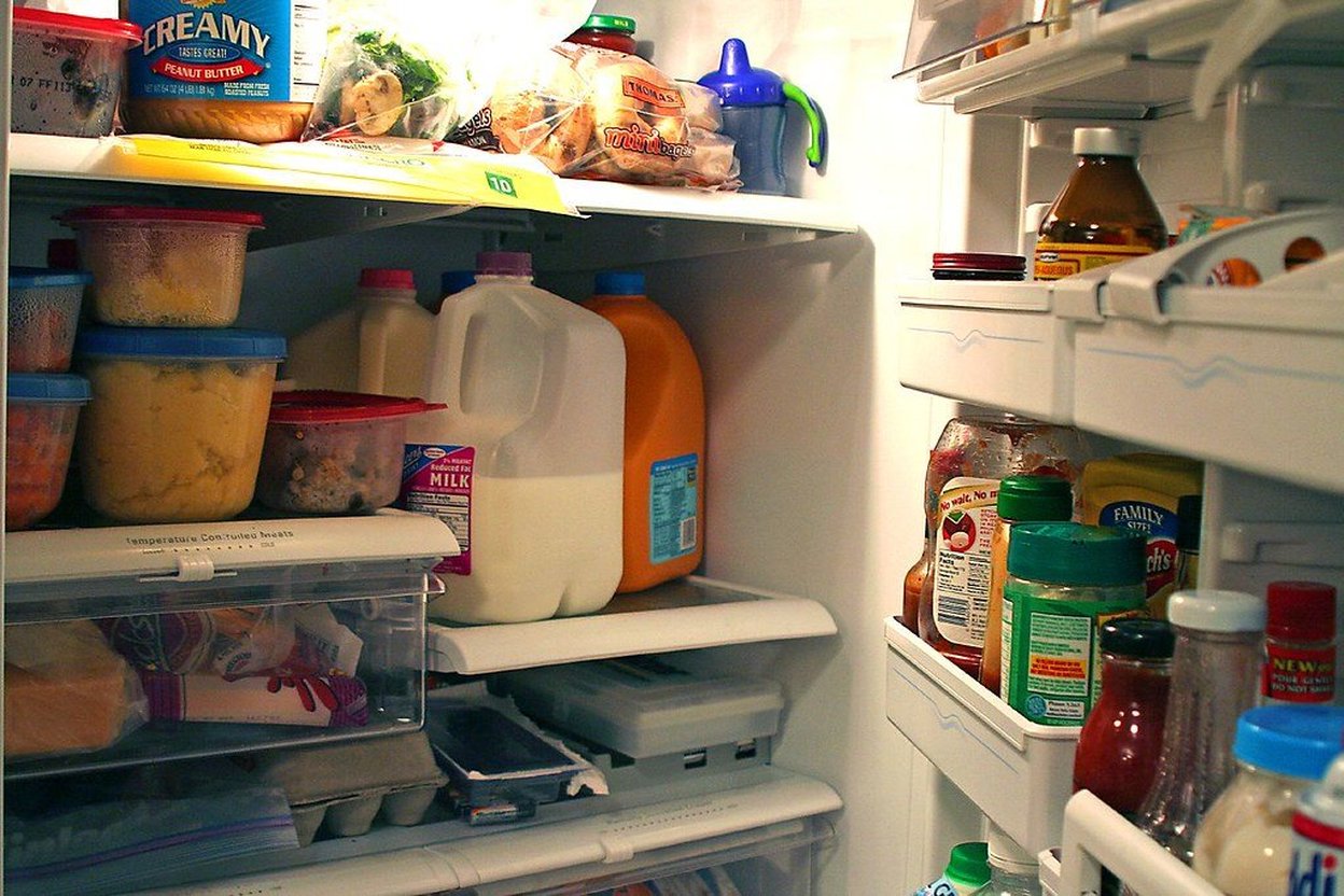 Refrigerator thermometer showing temperature reading during a power outage, with cooler and ice packs nearby for food preservation
