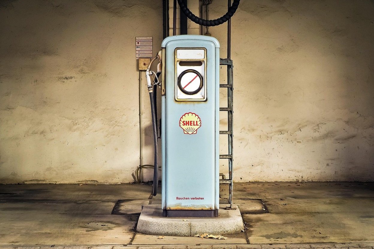 A man pulling the starter cord on a portable generator in a driveway