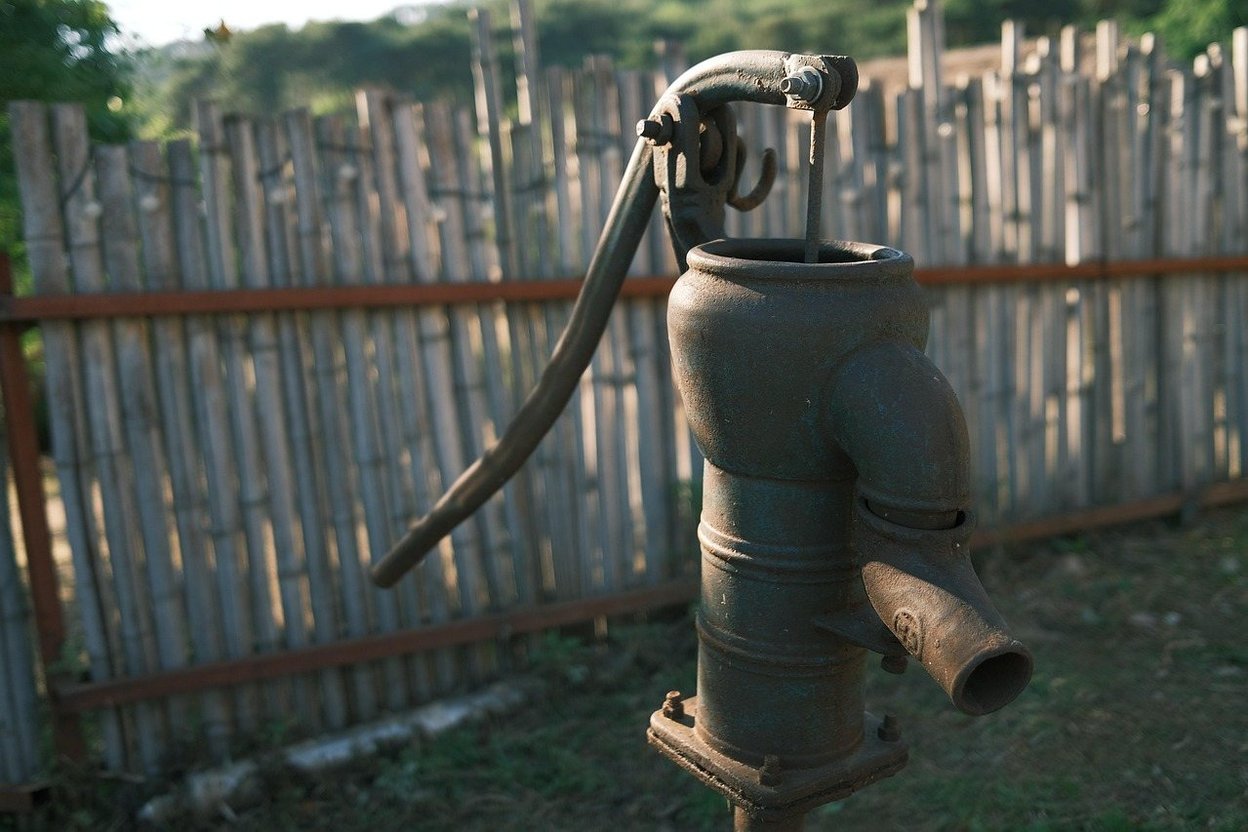 A well pressure tank and pipes in a basement