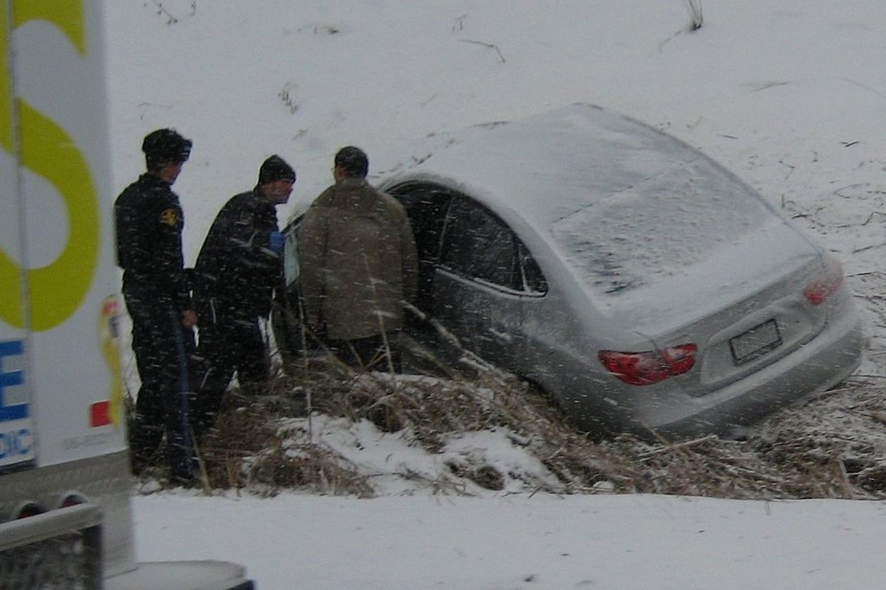 A car driving on a snowy road in winter